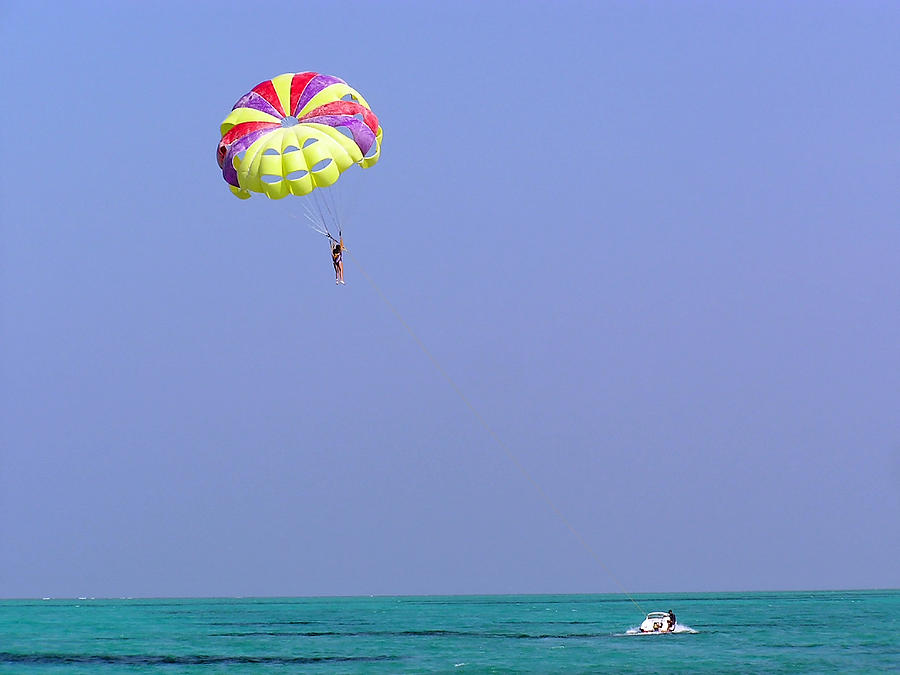 Parasailing over the green water of the Arabian Sea in the Lakshadweep Islands Photograph by Ashish Agarwal