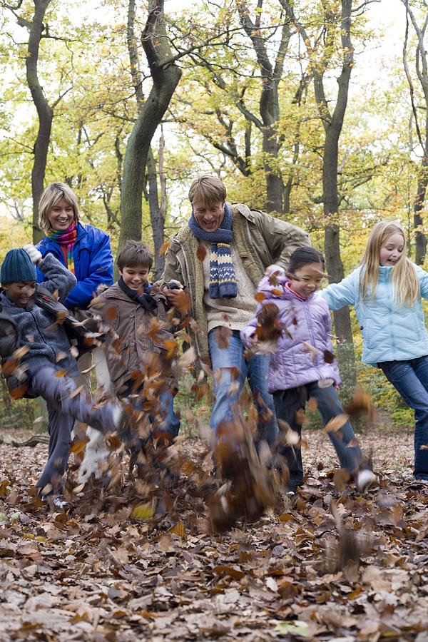 Fall Photograph - Parents And Children Playing In A Wood by Ian Boddy