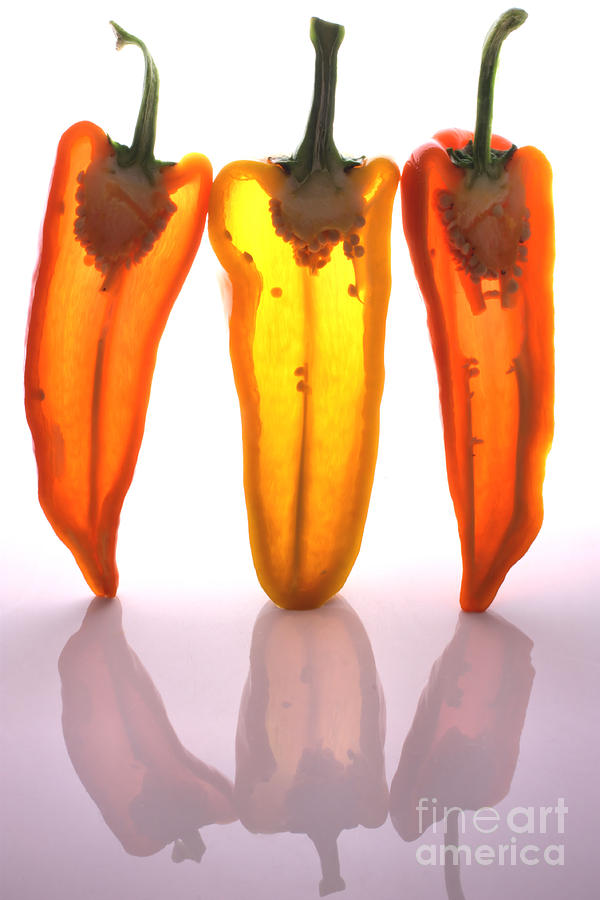 Peppers in half Photograph by Simon Bratt