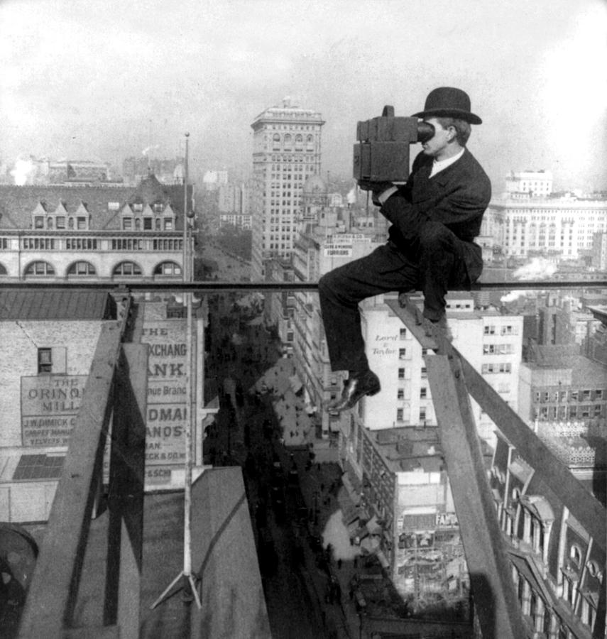 Photographing New York City - on a slender support 18 stories above pavement of Fifth Avenue - 1907 Photograph by International  Images