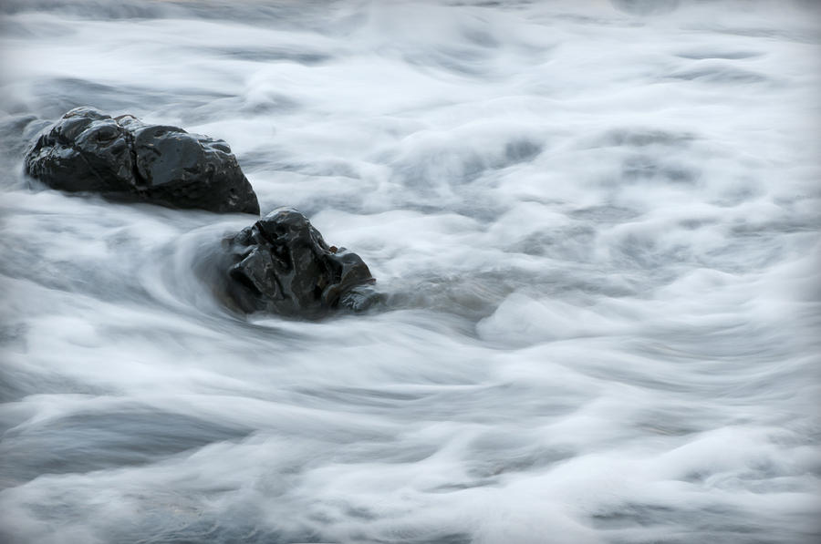 playing with waves 5 - Mediterranean sea foam playing with black stones in cala mesquida - menorca Photograph by Pedro Cardona Llambias