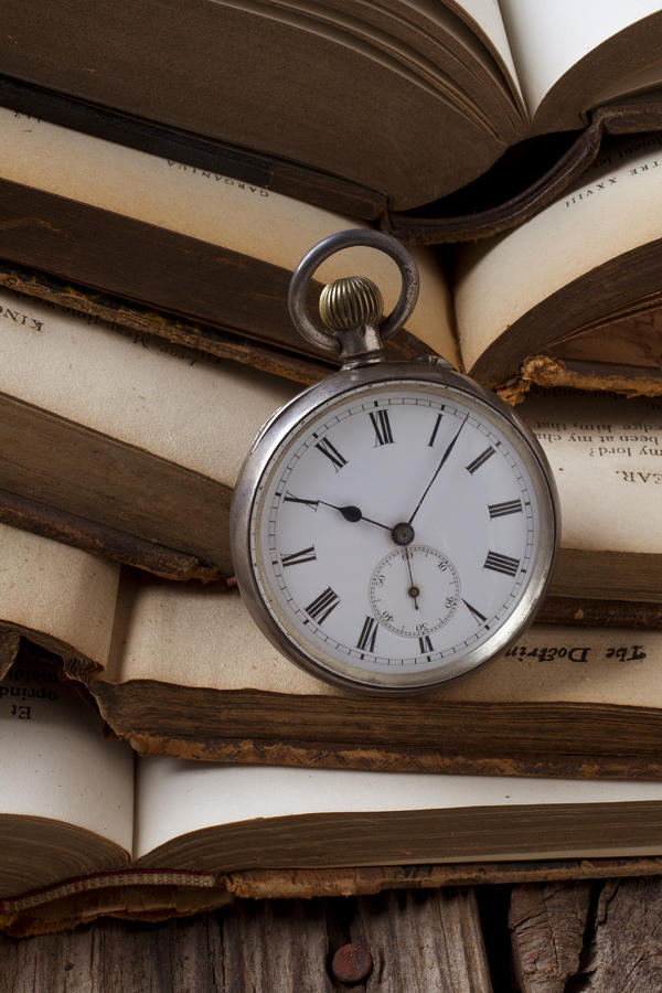 Book Photograph - Pocket watch on pile of books by Garry Gay