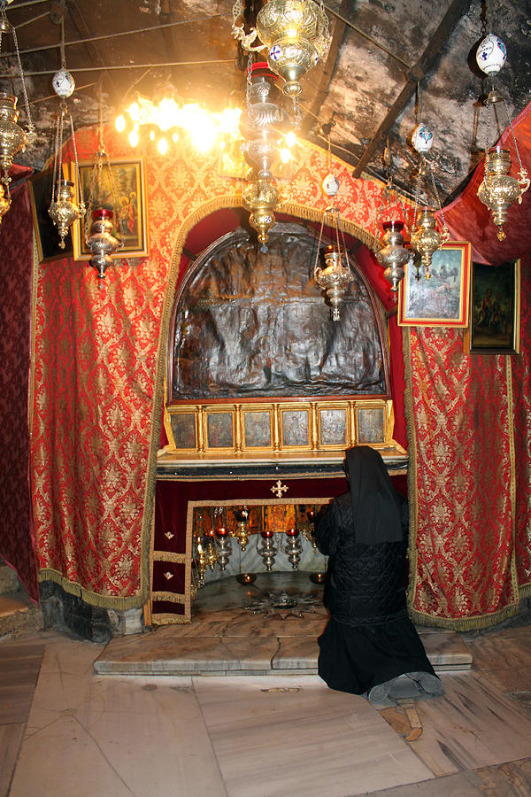 Praying Next to Silver Star in Nativity Grotto Photograph by Munir Alawi