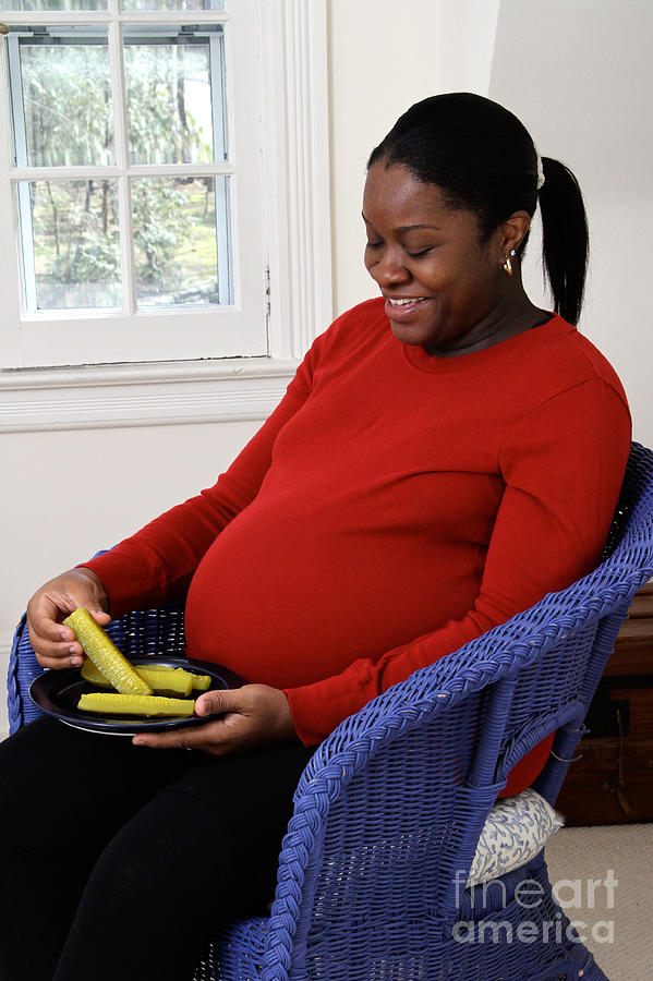 Pregnant Woman Eating Pickles Photograph by Photo Researchers