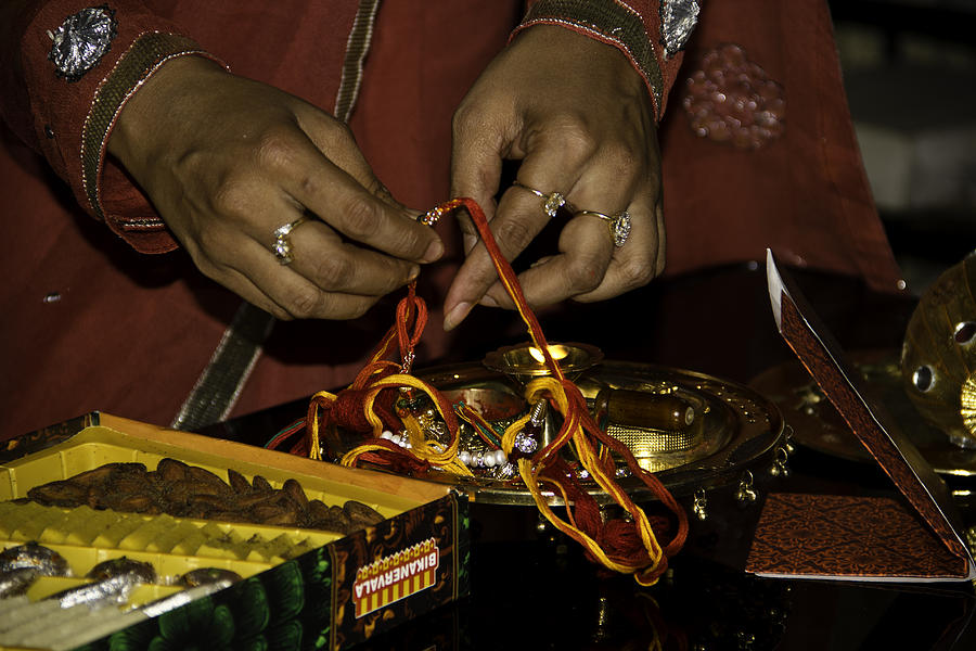 Preparing the decorations on a plate for a Hindu festival Photograph by Ashish Agarwal