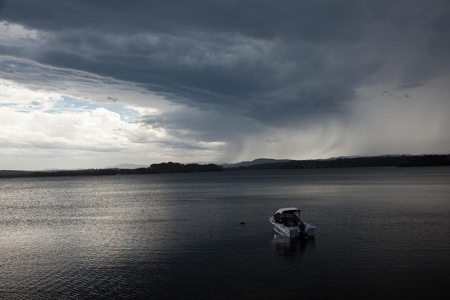 Rain front over lake. Photograph by Carole Hinding