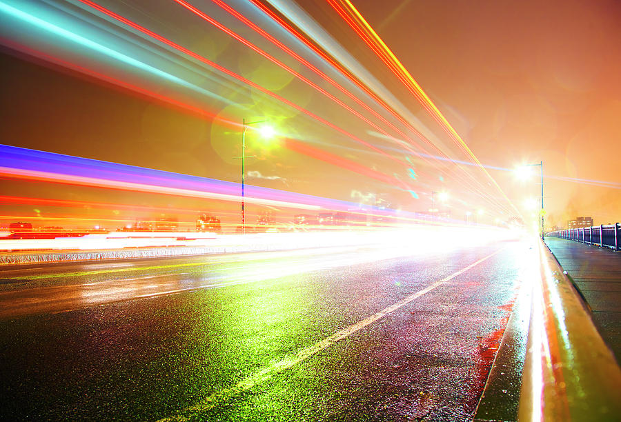 Rainy Road With Blurred Traffic At Night Photograph by Thomas Northcut