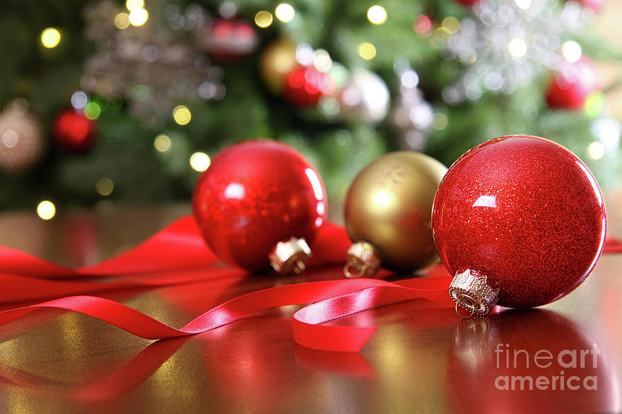 Christmas Photograph - Red Christmas ornaments on a table by Sandra Cunningham