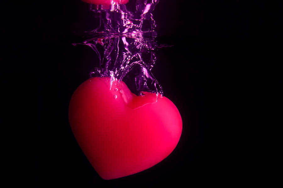 Red Heart Dropping Into Water On Black Photograph by Riaan Roux