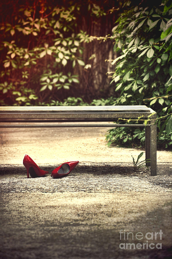 Red stiletto shoes left under a park bench by Sandra Cunningham