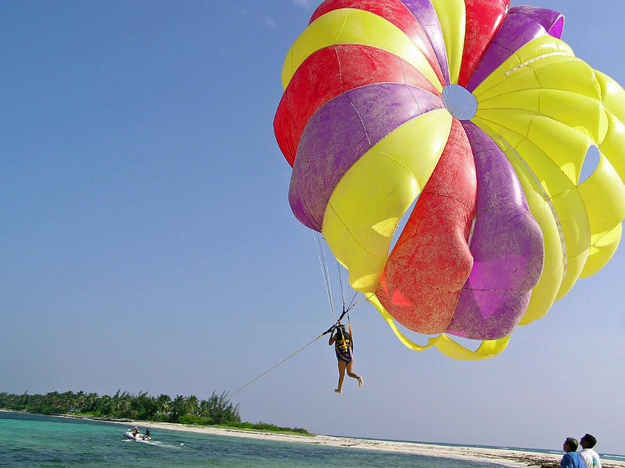 Riding a colorful parasail behind a speedboat in the Lakshadweep Islands Photograph by Ashish Agarwal