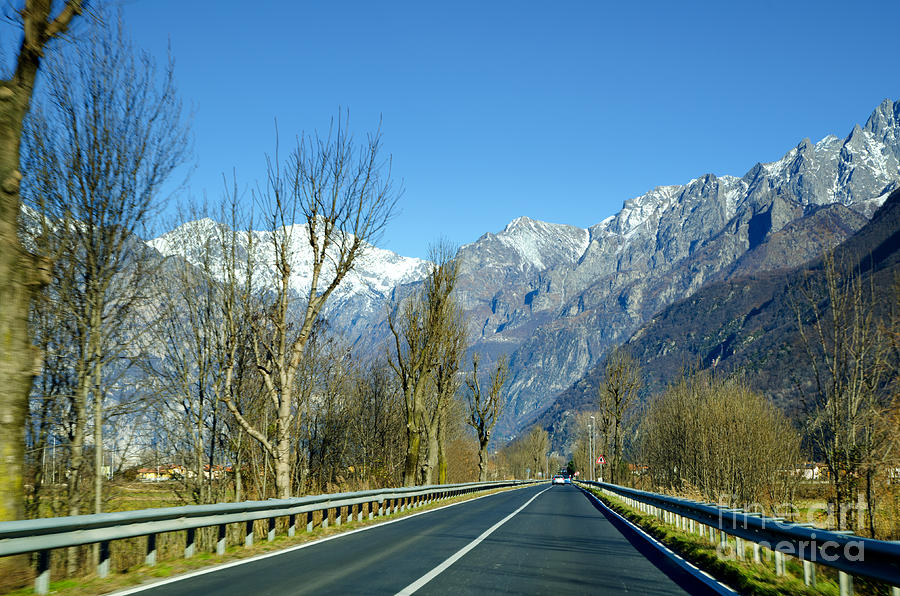 Road and snow-capped mountain Photograph by Mats Silvan