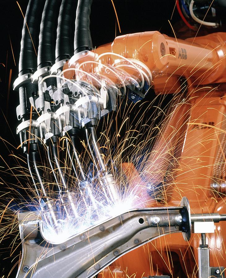 Robot Arm Spot-welding A Car Suspension U Photograph by David Parker