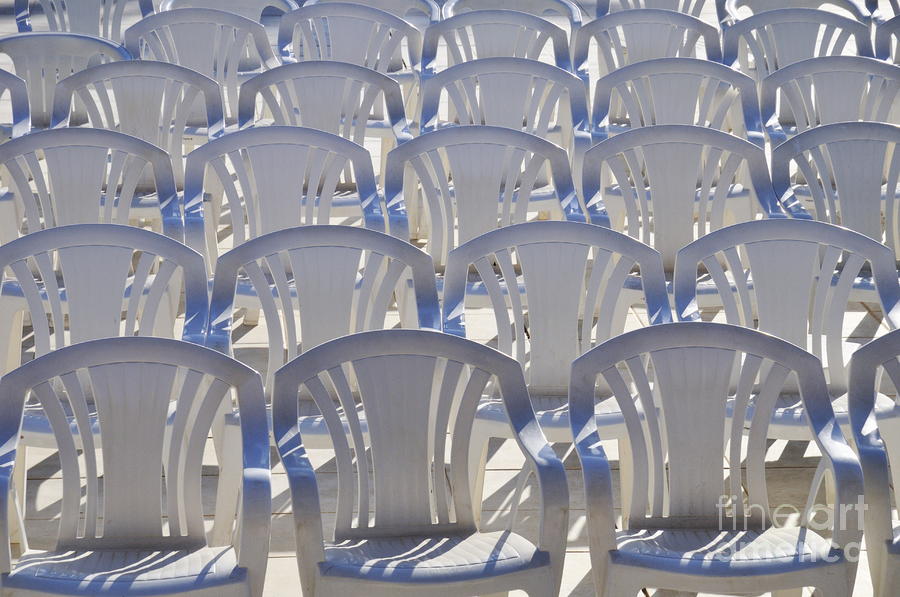 Conformity Photograph - Rows of empty white plastic chairs by Sami Sarkis