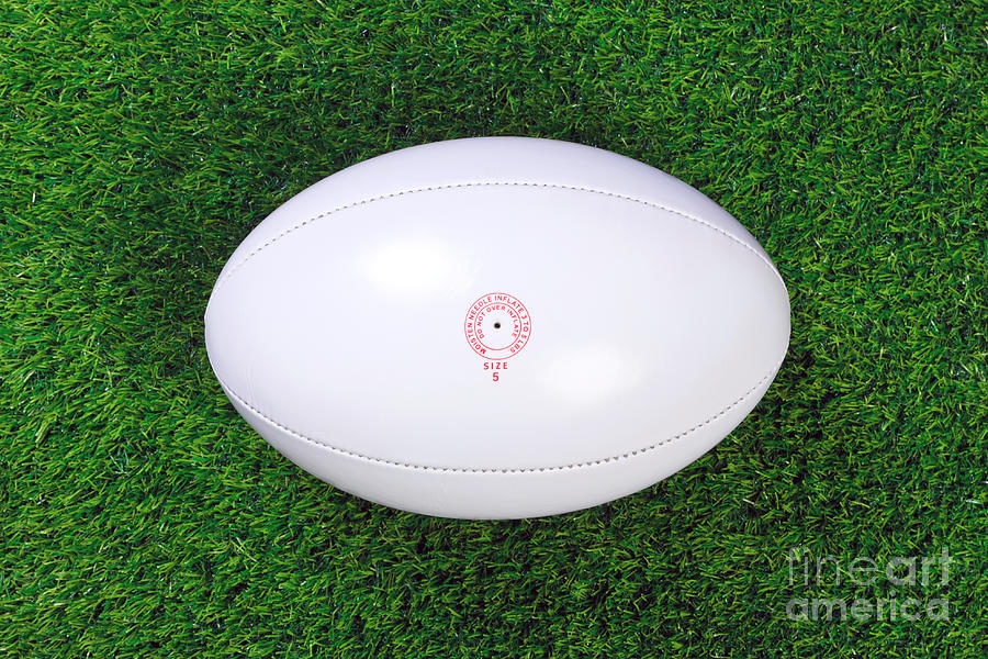 Download Rugby ball on grass Photograph by Richard Thomas