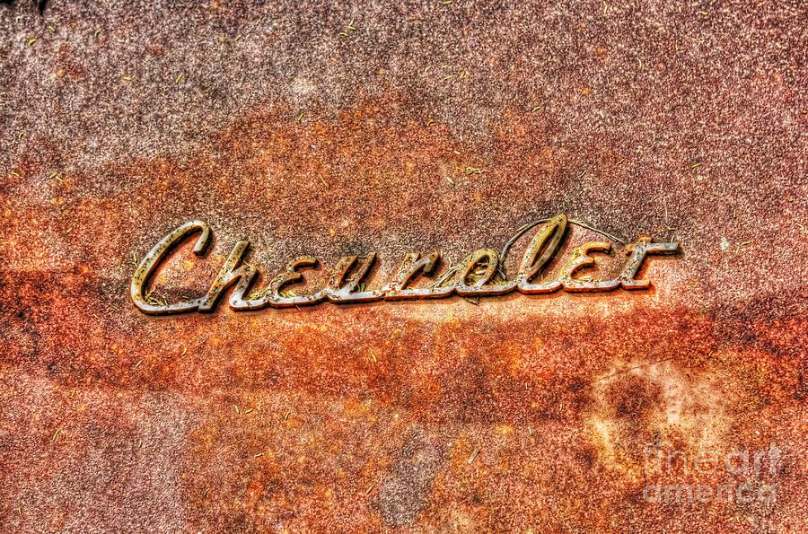 Rusted Antique Chevrolet Logo Photograph by Dan Stone