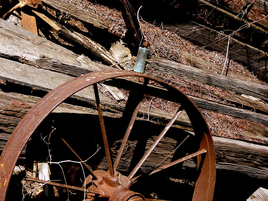 Rusty Wooden Wagon Wheel Photograph by Jeff Lowe