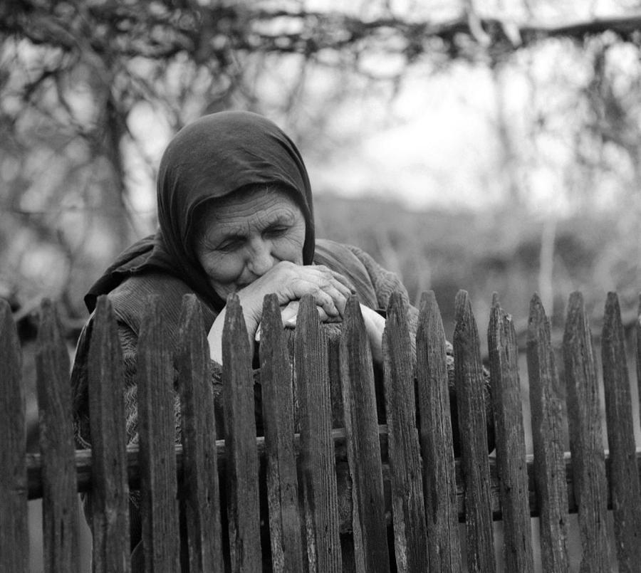 Sad peasant at the fence Photograph by Emanuel Tanjala