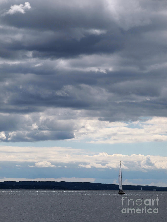 Sailboat under clouds Photograph by Gene  Marchand