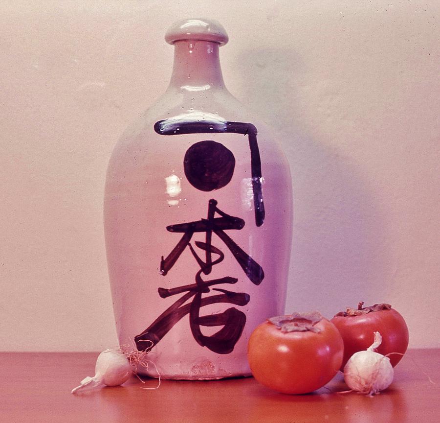 Sake jug with Persimmon and Garlic Photograph by Craig Wood