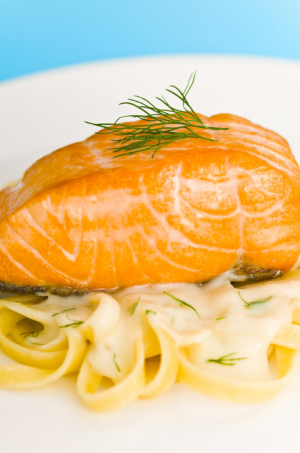 Salmon steak on pasta decorated with dill closeup Photograph by U Schade