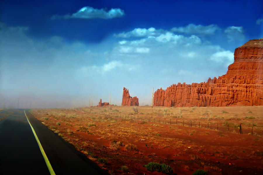 Sandstorm moving in to Monument Valley Photograph by Ellen Heaverlo