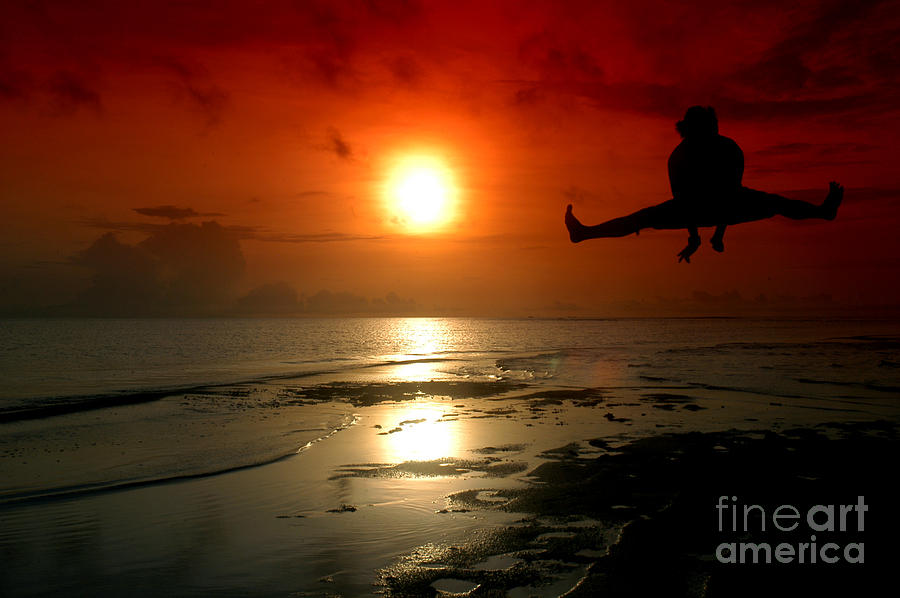 Silhouette Of A Man Jumping With Sunrise Baground Photograph
