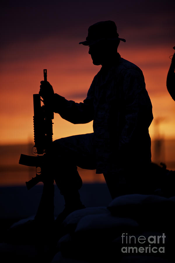 Sunset Photograph - Silhouette Of A U.s Marine On A Bunker by Terry Moore