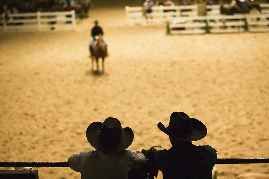 Silhouette Of Cowboys At Indoor Rodeo Photograph by Walter Bibikow