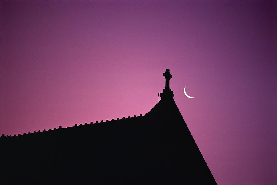 Silhouette Of Roof With Crescent Moon Photograph by Paul Simcock