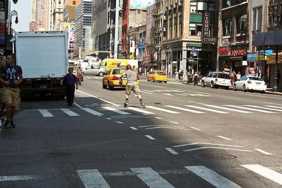 Skater Catching a Cab in Manhattan Photograph by Ann Murphy