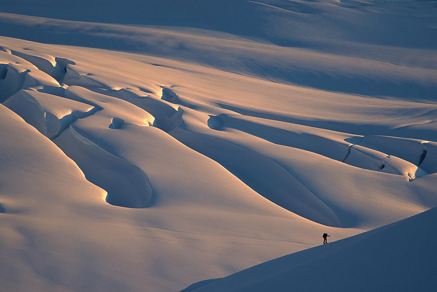 Skier And Crevasse Patterns At Sunset Photograph by Colin Monteath