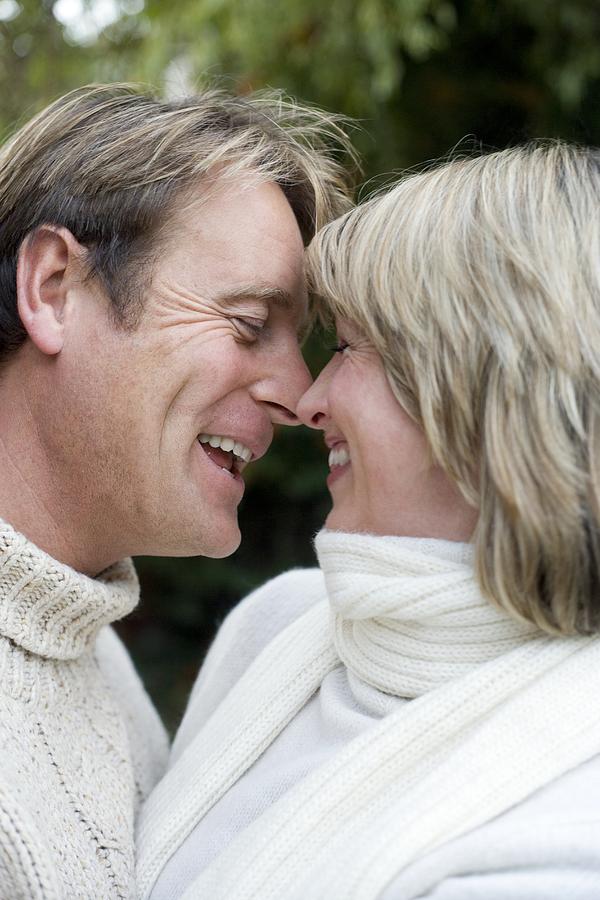 Clothing Photograph - Smiling Couple Embracing by Ian Boddy