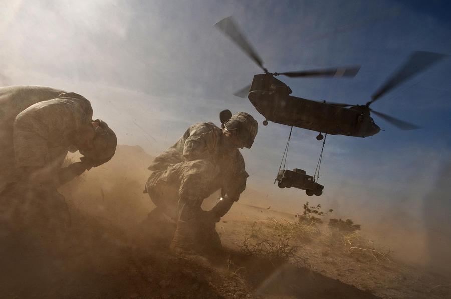 Helicopter Photograph - Soldiers In The Dust Of A Chinook by Everett