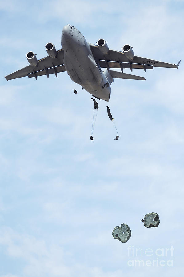 Airplane Photograph - Soldiers Jump From A C-17 Globemaster by Stocktrek Images