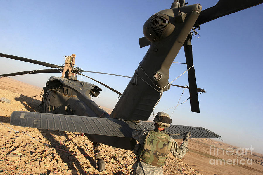Desert Photograph - Soldiers Prepare A Uh-60 Black Hawk by Stocktrek Images