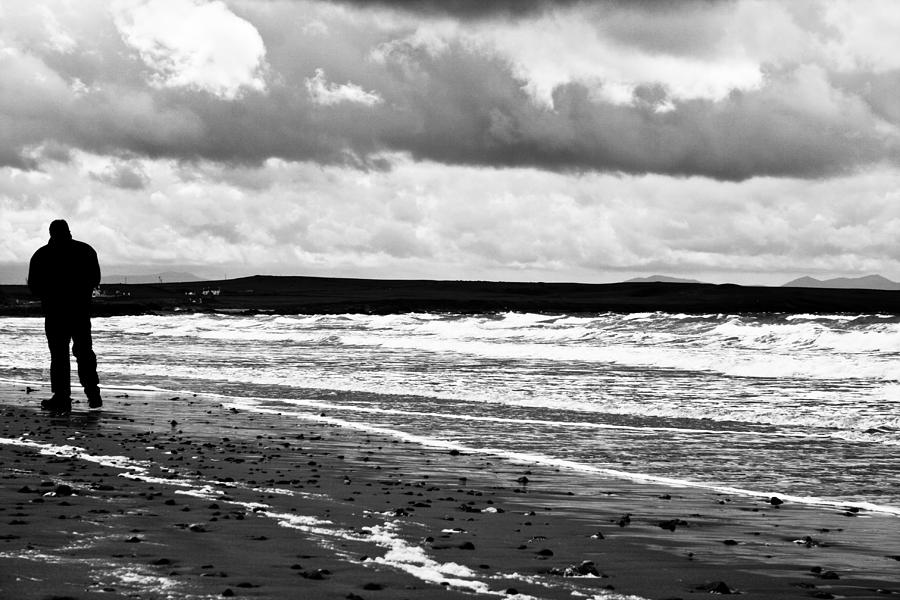 Winter Photograph - Solitary man on a lonely beach by Georgia Clare