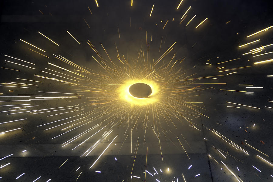 Sparks flying in all directions from a spinning firecracker Photograph by Ashish Agarwal