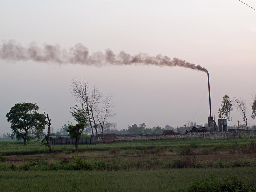 Spewing smoke and pollution into a green rural environment Photograph by Ashish Agarwal