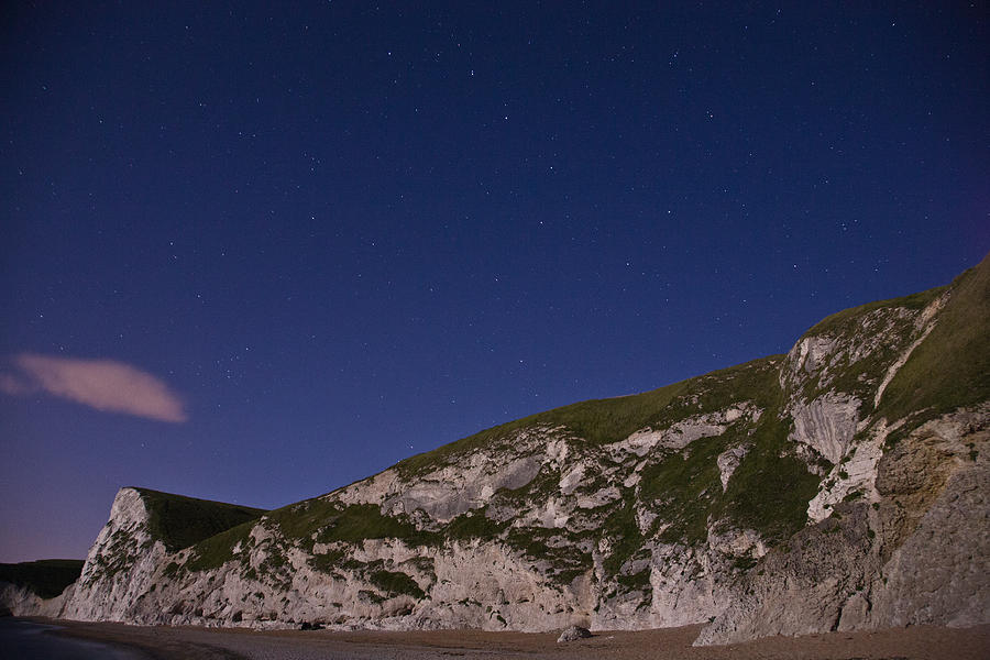 Starry night at Durdle Door Photograph by Ian Middleton