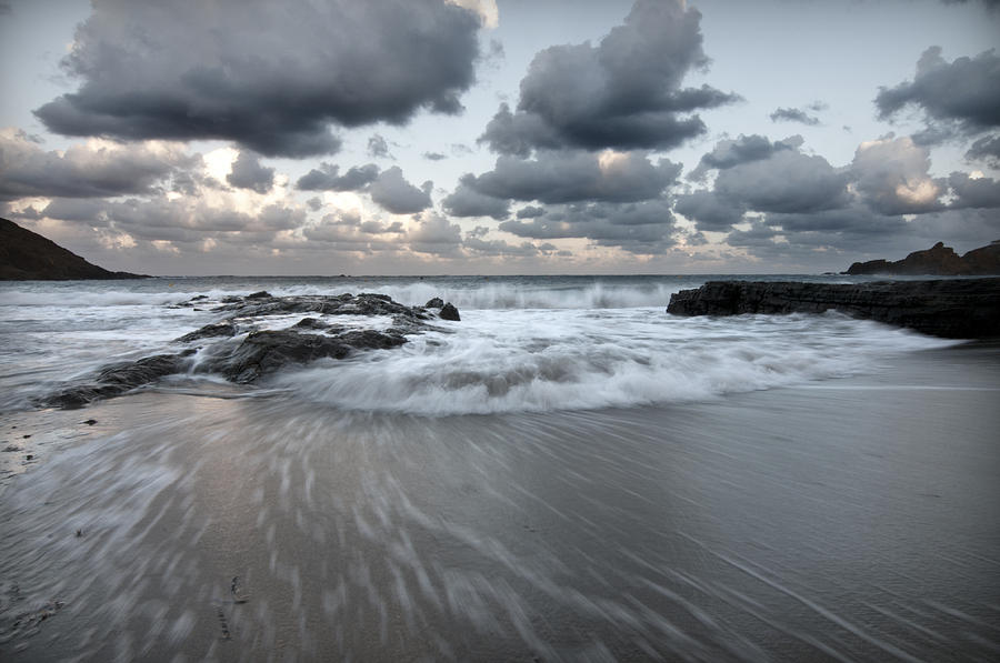 stormy beach 1 - Cala Mesquida north coast of menorca after storm a cloudy and bluish landscape Photograph by Pedro Cardona Llambias