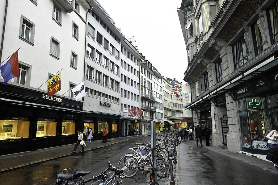 Street in Lucerne with cycles and rain Photograph by Ashish Agarwal
