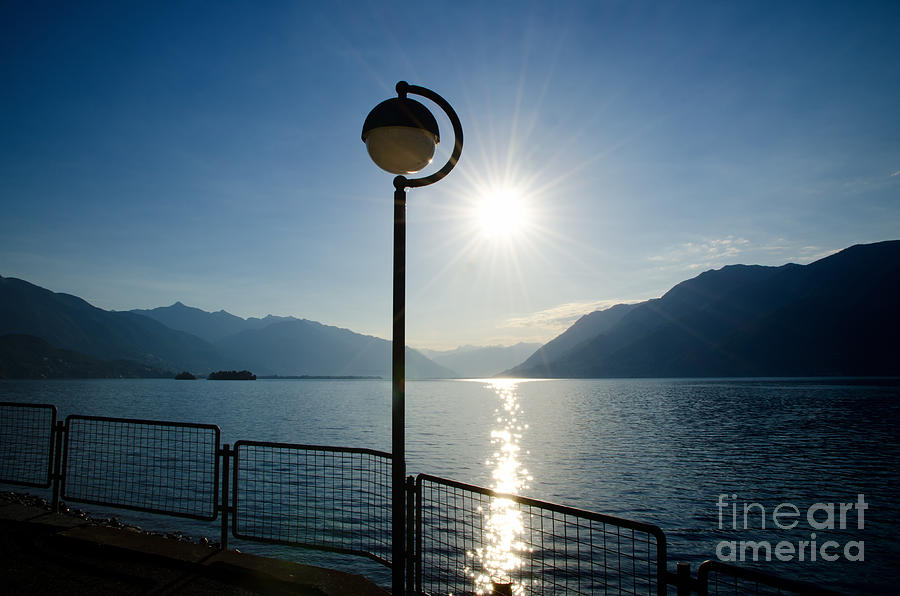Mountain Photograph - Street lamp and water by Mats Silvan