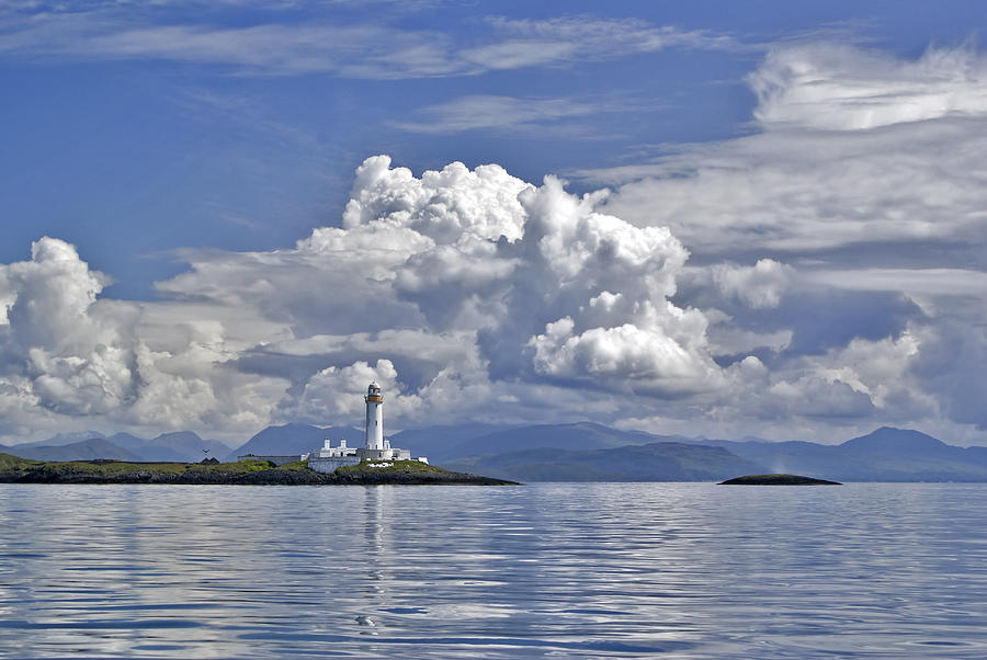 Summer clouds over Lismore lighthouse Photograph by Gary Eason