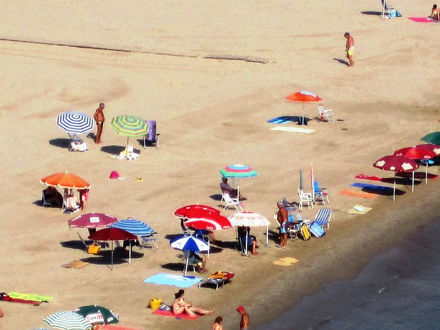 Sun Bathers and Beach Umbrellas in Peniscola Spain Photograph by John Shiron