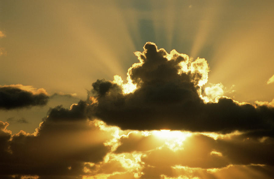 Sun Rays Beam From Behind Cumulus Clouds Photograph by Aad Schenk