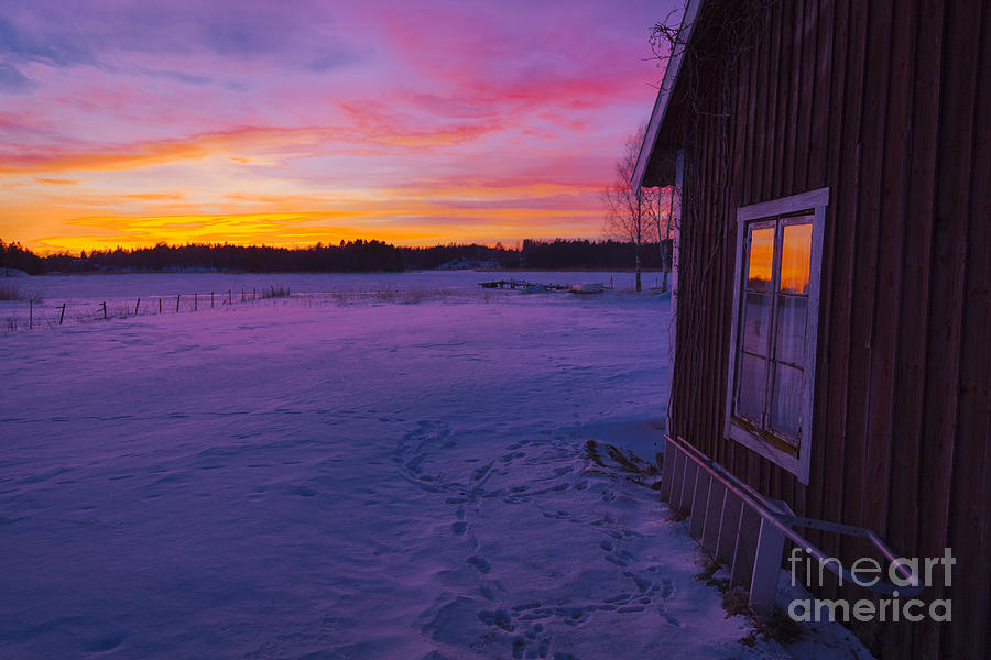 Sunset Photograph - Sun setting over winter landscape and a small house by Kathleen Smith