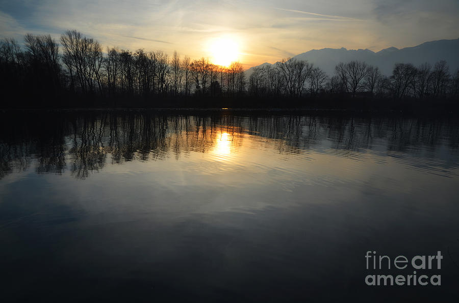 Sunset over a lake Photograph by Mats Silvan