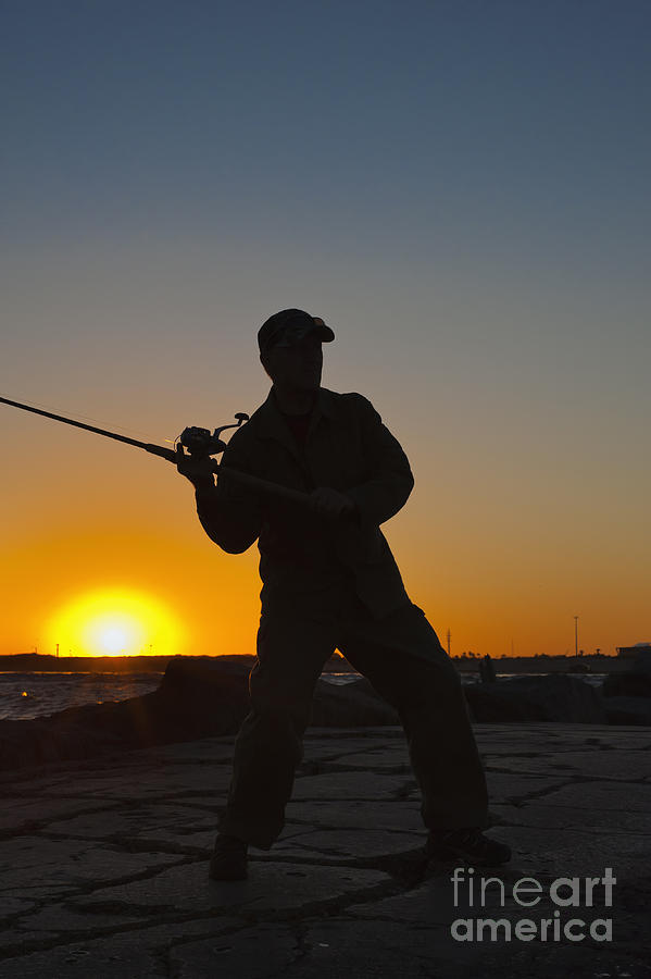 Sunset silhouette of Fisherman casting the fishing rod Photograph by Andre  Babiak - Fine Art America
