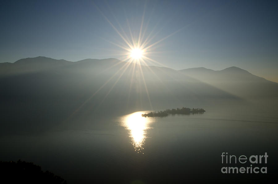 Sunshine over an alpine lake Photograph by Mats Silvan